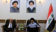 Iraqi Prime Minister Haider al-Abadi, who's political bloc came third in a May parliamentary election, (L) meets with cleric Moqtada al-Sadr, who's bloc came first, in Najaf, Iraq June 23, 2018. REUTERS/Alaa al-Marjani