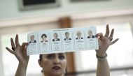 An election committee member shows a ballot displaying a vote for Recep Tayyip Erdogan, Turkish President and leader of the Justice and Development Party (AKP) at a polling station during the Turkish presidential and parliamentary elections in Istanbul on