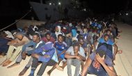 Migrants wait at a naval base in Tripoli, after being rescued in the Mediterranean on June 24, 2018. Some five hundred African migrants were rescued in the Mediterranean by the country's coast guards on June 24, 2018, according to the Libyan navy. / AFP /