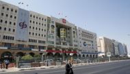 A man crosses Grand Hamad street where banks and financial institutions are located in Doha (Reuters)