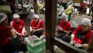 Thai volunteers prepare food in a mobile canteen at the Tham Luang cave area as rescue operations continue for 12 boys and their coach trapped at the cave at Khun Nam Nang Non Forest Park in the Mae Sai district of Chiang Rai province on July 5, 2018.  AF