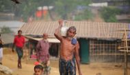 A Rohingya man walks through the mud along with a kid as they take shelter at a makeshift camp in Coxs' Bazar, Bangladesh on September 24, 2017. (Zakir Hossain Chowdhury / Anadolu Agency) 