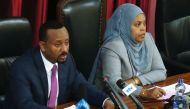 Ethiopia's newly elected Prime Minister Abiy Ahmed (L), flanked by parliament speaker, Muferiat Kamil, addresses the members of parliament inside the House of Peoples' Representatives, during a meeting for the approval of 2018/19 budget in Addis Ababa, Et