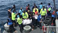 Thai rescue personnel aboard a search and rescue ship recover a body from a capsized tourist boat at sea off Phuket on July 6, 2018.  AFP / Sakorn Petchthong