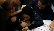 The mother of a Palestinian, who was killed at the Israel-Gaza border during a protest, reacts over his body in Gaza city July 6, 2018. Reuters/Mohammed Salem 