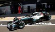 Mercedes' Lewis Hamilton drives in the pit lane during qualifying. (REUTERS/Andrew Yates)