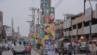 (FILES) In this file photo taken on June 28, 2018 Pakistani motorists drive along a road with posters of candidates taking part in the forthcoming general elections, in the garrison city of Rawalpindi. AFP / Aamir Qureshi 