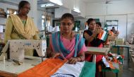 This photo taken on May 9, 2018 shows employees of Khadi Gramodyog Samyukta Sangh stitching together an Indian national flag at the Indian National Flag Production Centre in Bengeri in the southern state of Karnataka. AFP / Manjunath Kiran  