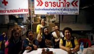Volunteers celebrate at a press center near Tham Luang cave complex in the northern province of Chiang Rai, Thailand, July 10, 2018. (REUTERS/Soe Zeya Tun)