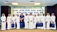 QNB officials with the students within QCDC’s career camp 2018, during their visit to the bank’s Mathaf building.