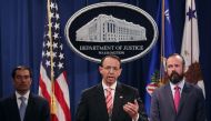 US Deputy Attorney General Rod Rosenstein (C), Acting Principal Associate Deputy Attorney General Edward O'Callaghan (R) and Assistant Attorney General John Demers and holds a news conference at the Department of Justice July 13, 2018 in Washington, DC. C