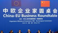 Chinese Premier Li Keqiang, center right, looks over to European Commission President Jean-Claude Juncker, center left, as they attend the China-EU Business Roundtable held at the Great Hall of the People in Beijing, China, Monday, July 16, 2018. Ng Han G