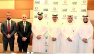 Mahday Al Hebabi (third right), Vodafone Qatar’s Head of Large Sales; and Abdulla Alyafei (second right), ASTAD’s IT Director;  with other ASTAD and Vodafone senior executives during the signing ceremony.