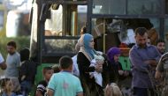 People are seen as they are evacuated from the villages of al-Foua and Kefraya, Syria July 19, 2018. Reuters/Khalil Ashawi