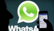 A Whatsapp App logo is seen behind a Samsung Galaxy S4 phone that is logged on to Facebook in the central Bosnian town of Zenica, February 20, 2014 (Reuters) 