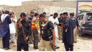 Rescue 1122 members and police officers inspect a damaged vehicle after a suicide bomber blew himself up near the vehicle of Ikramullah Gandapur in Looni Darbar area of Dera Ismail Khan district, when he was on his way for an election rally in the area,” 
