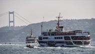 A ferry boat carries swimmers to the start point on the Bosphorous river before taking part in the Bosphorus Cross Continental Swim event on July 22, 2018. The race takes participants 6 kms down the Bosphorus Strait from the Asian side of Istanbul to the 