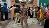 Army soldier stands to guard electoral workers, who gather to collect election materials, ahead of general election in Karachi, Pakistan July 24, 2018. (REUTERS/Akhtar Soomro)