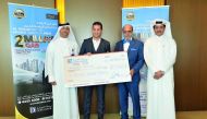 Dr R Seetharaman (second right), CEO of Doha Bank, and other officials handing over a big cheque template of QR1m to the winner of Doha Bank’s 63rd millionaire for Al Dana saving schemes.