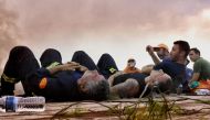 Firefighters from Cyprus rest during a wildfire at the village of Kineta, near Athens, on July 25, 2018.  AFP / Valerie Gache
