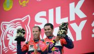 Overdrive Racing’s Qatari driver Nasser Saleh Al Attiyah (right) and French co-drive Mathieu Baumel celebrate with their trophies after finishing second in the Silk Way Rally 2018, at the Red Square in Moscow, Russia yesterday.