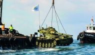 Environmental activists dropping off old battle tanks provided by the Lebanese Armed Forces to create new habitat for marine life into the Mediterranean Sea, about three kilometres off the coast of the southern Lebanese port city of Sidon, yesterday.