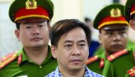 Phan Van Anh Vu (Vu Nhom) listens during the verdict session of his trial at a court in Hanoi, Vietnam July 30, 2018. VNA/Doan Tan via Reuters