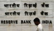 An Indian man walks past the entrance of the Reserve Bank of India (RBI) head office in Mumbai on August 1, 2018. (AFP / Punit PARANJPE)
