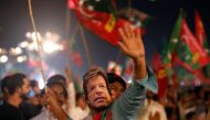 A supporter of Imran Khan, chairman of the Pakistan Tehreek-e-Insaf (PTI), political party, wears a mask and dance on party songs during a campaign rally ahead of general elections in Karachi, Pakistan July 22, 2018. (REUTERS/Akhtar Soomro/File Photo)