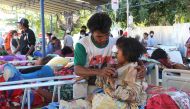 Injured victims rest at a makeshift hospital in Pemenang, North Lombok on August 6, 2018, the day after a 6.9 magnitude earthquake struck the area.  AFP / Pikong 