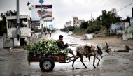 A Palestinian boy rides a donkey cart in Beit Hanun, northern Gaza Strip, (AFP file photo / Mahmud Hams) 