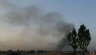 This screen grab taken from AFPTV video on August 10, 2018 shows smoke rising into the air after Taliban militants launched an attack on the Afghan provincial capital Ghazni, with terrified residents cowering in their homes amid explosions and gunfire.  /