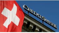 Switzerland's national flag flies next to the logo of Swiss bank Credit Suisse at a branch office in Luzern, Switzerland October 19, 2017. Reuters/Arnd Wiegmann