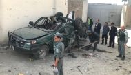 Afghan policemen inspect a damaged police vehicle after a suicide attack near the The Independent Election Commission (IEC) office in Kabul, Afghanistan August 13, 2018.REUTERS/Sayed Hassib