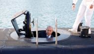 Israeli Prime Minister Benjamin Netanyahu climbs out after a visit inside the Rahav the fifth submarine in the fleet after it arrived in the Haifa port January 12, 2016. Reuters/Baz Ratner