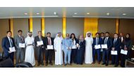 Dr R Seetharaman (seventh left), Group CEO of Doha Bank, and other senior officials and employees of the Bank at the award ceremony.