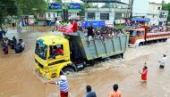 People travel in a truck to a safer place as flood waters ravaged the National Highway 47 in Ernakulam district of Kochi, in the Indian state of Kerala, on August 17, 2018.  AFP 