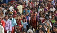 Flood-affected people wait to receive food inside a college auditorium, which has been converted into a temporary relief camp, in Kochi in the southern state of Kerala, India, August 20, 2018. (REUTERS/Sivaram V)