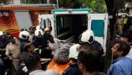  Firefighters carry the body of a victim killed in a fire at a residential building in Mumbai, India, August 22, 2018. REUTERS/Francis Mascarenhas 