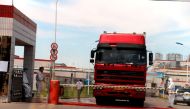 File photo of workers in protective suits are seen by a truck at a plant of pork processor Henan Shuanghui Investment & Development, a subsidiary of WH Group, following a discovery of pigs infected by the African swine fever (ASF), in Zhengzhou, Henan Aug
