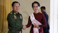 FILE PHOTO: Myanmar's Commander-in-Chief Min Aung Hlaing (L) shakes hands with National League for Democracy (NLD) party leader Aung San Suu Kyi before their meeting in Naypyitaw December 2, 2015. Reuters/Soe Zeya Tun

