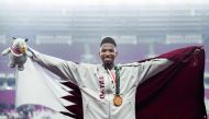 Gold medallist Qatar’s Abderrahman Samba celebrates during the victory ceremony for the men’s 400M hurdles event during the 2018 Asian Games in Jakarta yesterday. Samba (22), broke the Games record in the men’s 400m hurdles when he finished his run in 47.