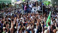 Supporters of the Tehrik-e-Labaik Pakistan (TLP) Islamist political party raise their hands as they listen to the speech of their leader during a protest march to condemn the cartoon competition by the Netherlands, in Lahore, Pakistan August 29, 2018. Reu