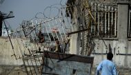 Afghan wrestlers and residents gather at the entrance gate after a blast that targeted wrestlers during a training session at the Maiwand Club, in Kabul on September 6, 2018. AFP / Wakil Kohsar 