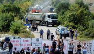 Kosovo war veterans block the road ahead of Serbian President Aleksandar Vucic's planned visit near the village of Banje, Kosovo, September 9, 2018. REUTERS/Laura Hasani