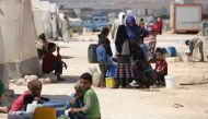 People who fled Syria's Idlib province are pictured at a camp in Kafr Lusin near the border with Turkey in the northern part of the province on September 9, 2018. AFP / Aref Tammawi
