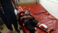 An Afghan wounded boy receives treatment at a hospital following multiple explosions in Jalalabad on September 11, 2018.  / AFP / NOORULLAH SHIRZADA 