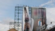 Workers roll advertising billboards along main road EDSA in preparation for the coming of Super Typhoon Mangkhut before it hits the main island of Luzon, in Quezon City, Metro Manila, Philippines, September 12, 2018. REUTERS/Erik De Castro