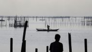 A worker recovers net in a fish pen before Super Typhoon Mangkhut hits the main island of Luzon, in Muntinlupa, Metro Manila, in Philippines, September 13, 2018. REUTERS/Erik De Castro