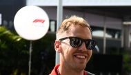 Ferrari's German driver Sebastian Vettel arrives at the Marian Bay Street Circuit in Singapore on September 13, 2018 ahead of the Singapore Formula One Grand Prix. / AFP / Roslan RAHMAN